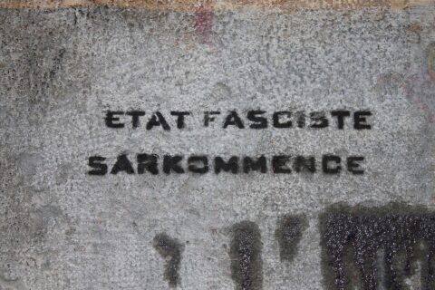 Anti-Sarkozy graffiti on the wall of the Collégiale Saint-André in Grenoble.
