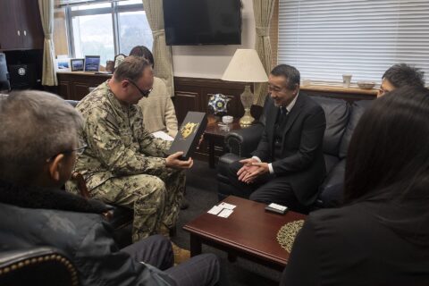 Mayor Takashi Kojima of Shintomi Town, Miyazaki Prefecture, gifts a bottle of sake to Capt. Michael Fontaine, Commander, Fleet Activities Sasebo (CFAS), during an office call at CFAS Headquarters in Sasebo, Japan, Feb. 7