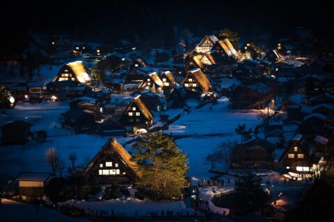 Night view of Shirakawa-go, a traditional Japanese village showcasing a building style known as gasshō-zukuri.