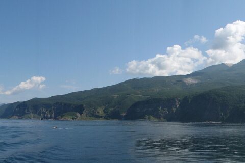View of Shiretoko National Park. Mount Iō (right) and Mount Shiretoko (far left) seen from Sea of Okhotsk. Six seperate photos wer taken and stiched together with a software.