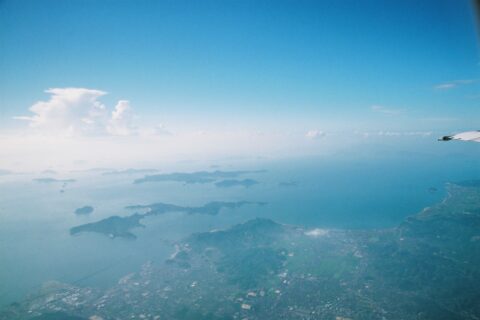 松山平野と忽那諸島。一番手前の島が興居島。(2006/08/23 In Flight, NH1750, JAPAN)。松山空港を海方向に離陸し松山市上空に戻って来て東方向に向かう。
