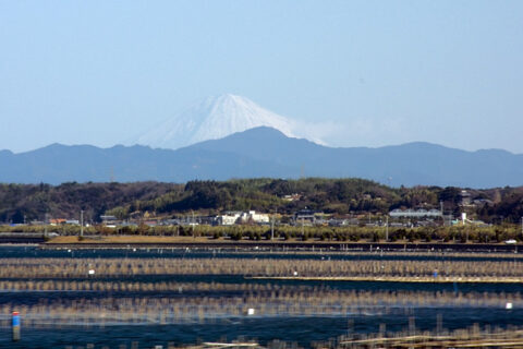 View of Mount Fuji across Lake Hamana. Photographed from a moving train on the Tōkaidō Shinkansen.