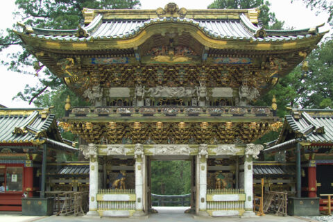 Yomeimon, the most famous gate at Toshogu, Nikko, Tochigi Prefecture, Japan, a UNESCO World Heritage Site. This is the view from the inner courtyard looking out through the gate. The top of a tall torii, located at the f